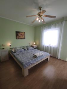 a bedroom with a bed and a ceiling fan at Apartman Mila in Novi Vinodolski
