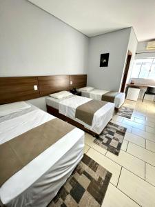 Ένα ή περισσότερα κρεβάτια σε δωμάτιο στο Nantes Executive Hotel