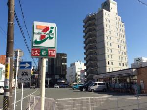 a sign for a gas station in a city at Ace Inn Matsusaka in Matsuzaka