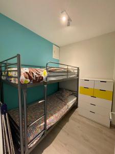 a bedroom with two bunk beds in a room at Duinenblik 5 in Nieuwpoort