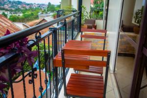 two benches sitting on a balcony with a view at Casabonita Villas in Kampala