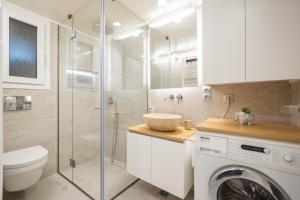 a bathroom with a toilet and a sink and a washing machine at Corfu Dream Home in Corfu Town +15 photos