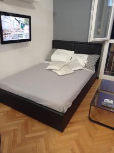 Cama en habitación con TV en la pared en Apartment Victoria, en Split