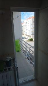 an open door to a balcony with a view of a street at Residential apartment with 3 bedrooms, elevator, and plenty of natural light, close to Lisbon in Montijo