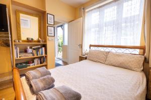 a bedroom with a bed and a large window at London VEGETARIAN Smoke & Pet Free En-suite with EV parking in Stone Grove