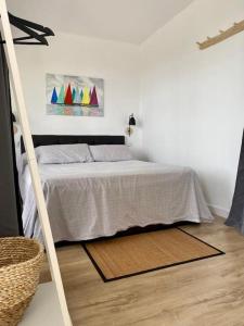 a bedroom with a bed and a wooden floor at La calma de Tossa in Girona +39 photos