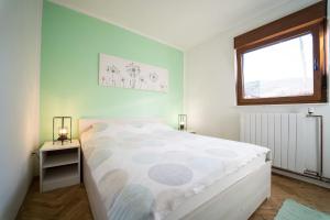 a bedroom with a large bed and a window at House Malkoc in Saborsko