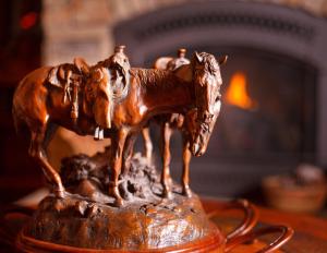 a statue of a horse on top of a fire place at Cowboy Village Resort in Jackson