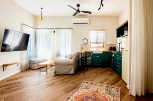 a kitchen and living room with a table and a couch at jabotinsky 37 in Zikhron Ya'akov
