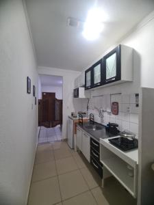 a kitchen with a sink and a counter top at Apartamento aconchegante in Jequié