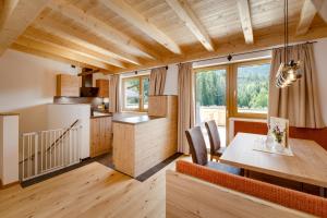 a kitchen and dining room with a table and chairs at Edenhauserhof in Innsbruck