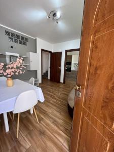a dining room with a table and a white table and chairs at Welcome Home Quartu Sant'Elena in Quartu SantʼElena +7 photos