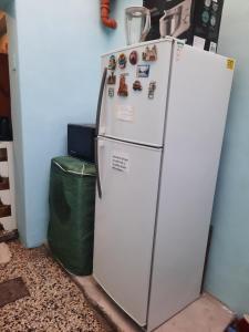 un frigorifero bianco in una stanza con un cestino di Kela a Buenos Aires