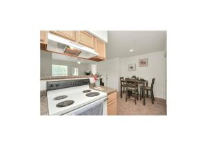 a kitchen with a stove and a dining room at Luxury 2 Bedroom Apartment with Balcony at Heights - Sleeps 4 in Houston