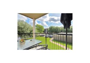 a view of a patio with a table and chairs on a balcony at Luxury 2 Bedroom Apartment with Balcony at Heights - Sleeps 4 in Houston