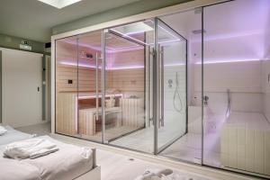 a glass shower in a room with a bed at Casa da Marechal - Boutique Hotel by Oporto Collection - Adults Only in Porto