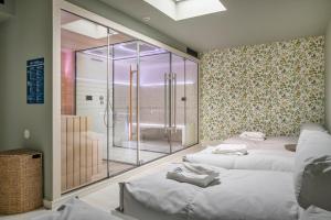 a room with three beds and a glass shower at Casa da Marechal - Boutique Hotel by Oporto Collection - Adults Only in Porto
