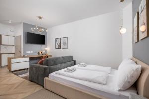 a living room with a bed and a couch at Apartments Madeleine in Rijeka