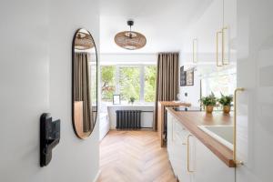 a bathroom with a sink and a mirror at Tallinn Oasis Studios by RevalHome in Tallinn