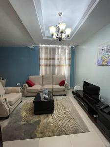 a living room with a couch and a table at IZA Serene city centre apartments in Kigali
