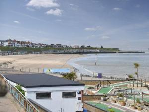 a view of a beach with a building and the ocean at Anchors Away in Margate