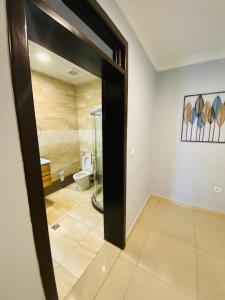 a bathroom with a shower and a toilet in a room at IZA Serene city centre apartments in Kigali