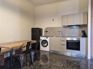 a kitchen with a table and chairs and a stove at Mosaic Apartments in Chania