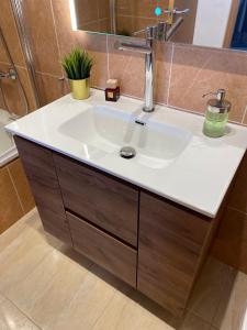 a bathroom with a white sink and a mirror at Apartamento HOUSE FRANMAR in Sant Jaume d'Enveja