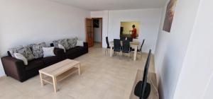 a living room with a couch and a table at Apartamento Prado in Finisterre