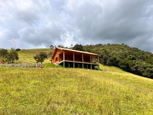 a building on top of a hill in a field at As 3 Casinhas no Paraiso em Cunha!! in Cunha