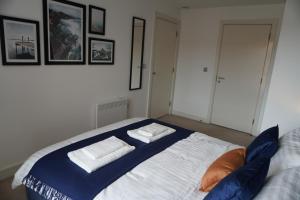 a bedroom with a large bed with two pillows on it at Your Perfect Business Suite, 2 beds 2 bathrooms Apartment, Free Parking, Monthly Stays, Business, Contractors in Hemel Hempstead