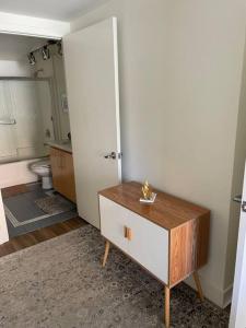 a room with a bathroom with a toilet and a table at The Palomino - Modern, Stylish, Secure Entry, Spacious Condo with 2 Master Bedrooms, WLK to Pier in Los Angeles