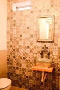 a bathroom with a sink and a mirror at En el Corazón de Valle, Casa Luz María. in Valle de Bravo +25 photos