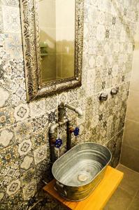 a sink in a bathroom with a mirror at En el Corazón de Valle, Casa Luz María. in Valle de Bravo