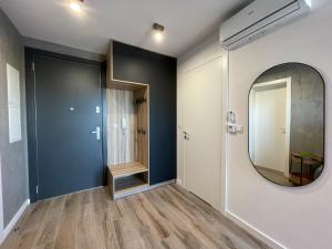 einen Flur mit Spiegel und Tür in der Unterkunft Stylowy Apartament - Port Mielno in Mielno