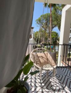 a porch with a swinging chair on a balcony at Boutique apartment 365 - Marbella in Marbella