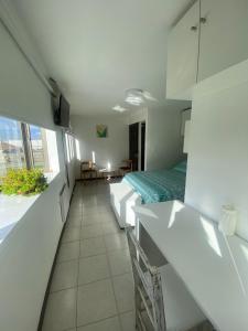 a hotel room with two beds and a balcony at Hostal Florecer in Angol