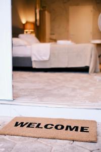 a welcome mat in front of a room with a bed at Studio Macharen in Macharen