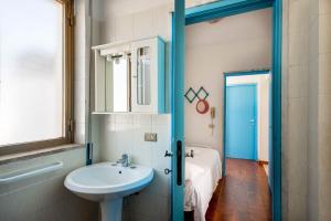 a bathroom with a sink and a toilet and a mirror at BED BIANCANEVE Attico in Villanova di Ostuni +51 photos