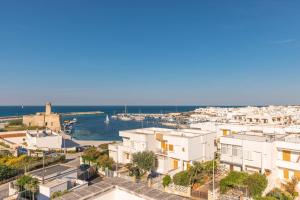 a view of a city with white buildings and the ocean at BED BIANCANEVE Attico in Villanova di Ostuni