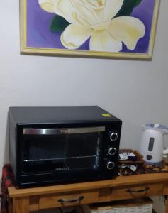 a microwave sitting on top of a wooden table at MAGUI CONCEPCION DEL URUGUAY in Concepción del Uruguay