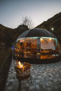 a dome tent with a fire in front of it at İstanbuldere Glamping in Sapanca