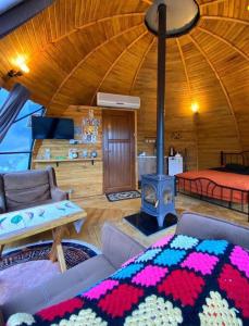 a living room with a bed and a fireplace at İstanbuldere Glamping in Sapanca