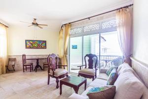 a living room with a couch and chairs and a table at Victorian Condominium, Cabarete! in Cabarete