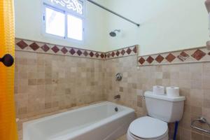 a bathroom with a tub and a toilet and a sink at Victorian Condominium, Cabarete! in Cabarete +15 photos