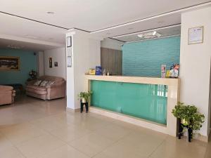 a hospital lobby with a large blue wall at Hotel Carolina Del Mar in Santa Marta