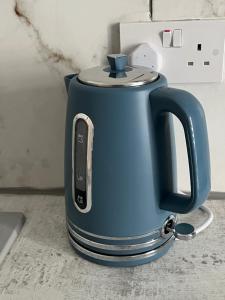 a blue tea kettle sitting on a counter at Bella Ripley in Ripley