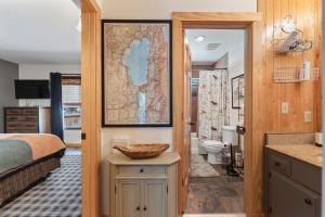 a bedroom with a bed and a bathroom with a sink at The Bear's Den Chalet in Stateline