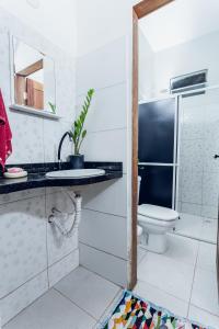 a bathroom with a sink and a toilet at Hostel Filhos da Promessa in Tucuruí