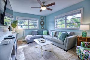 a living room with a couch and a table at Tropical Oasis, Heated Pool, Hot Tub, Near Siesta Key in Sarasota